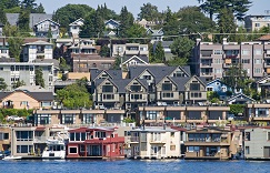Houseboats on water with condos and houses in background